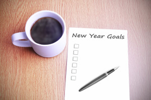 50398356 - coffee on the table with note writing new year goals.