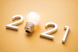metal numbers 2021 with a burning light bulb. New ideas in the new year.