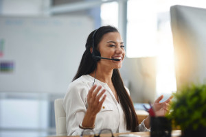 Laughing, agent or happy woman in call center consulting, speaking or talking at virtual assistant help desk. Smile, friendly or funny sales consultant in telemarketing customer services or telecom